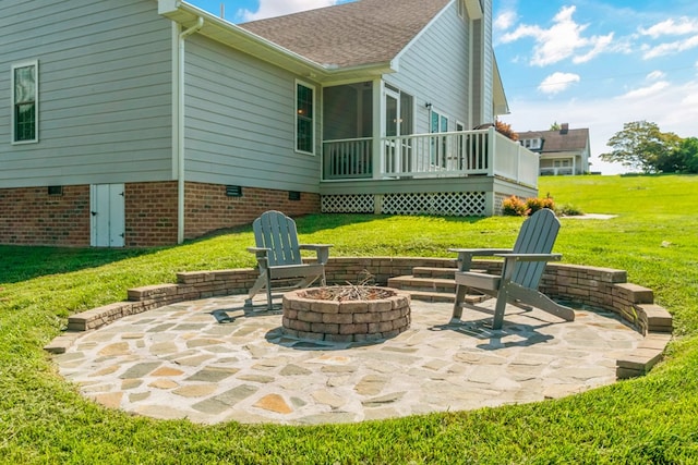 view of patio / terrace featuring a wooden deck and a fire pit