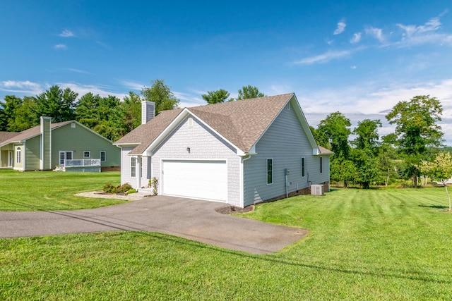 view of home's exterior with a garage, a yard, and central AC unit