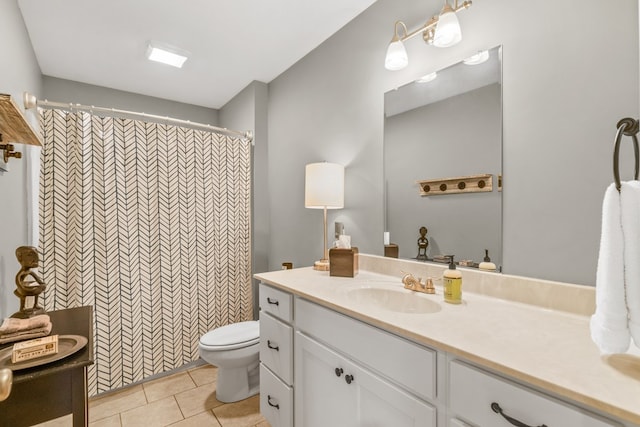 bathroom with vanity, tile patterned floors, toilet, and a shower with shower curtain