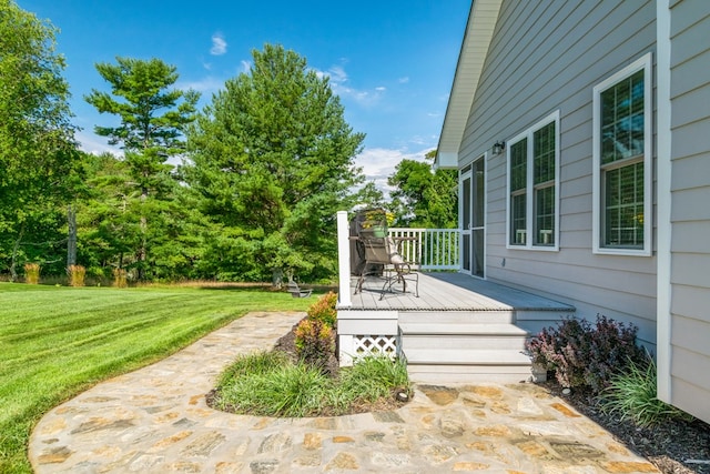 wooden deck featuring a yard