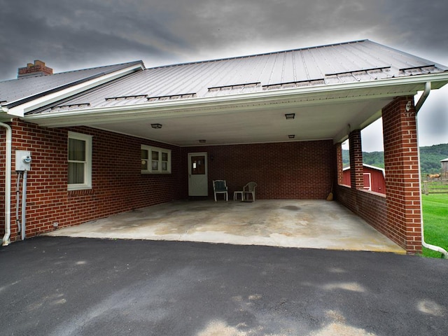 3878 Blue Grass Trl, Saltville, VA 24370 - view of front of house featuring an attached carport, brick siding, asphalt driveway, a standing seam roof, and a metal roof