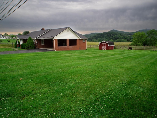 3878 Blue Grass Trl, Saltville, VA 24370 - rear view of property featuring an outdoor structure, driveway, brick siding, a chimney, and a mountain view