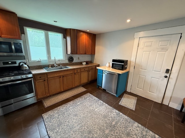 108 Square St, Bluefield, VA 24605 - kitchen with appliances with stainless steel finishes, a sink, dark tile patterned floors, brown cabinets, and recessed lighting