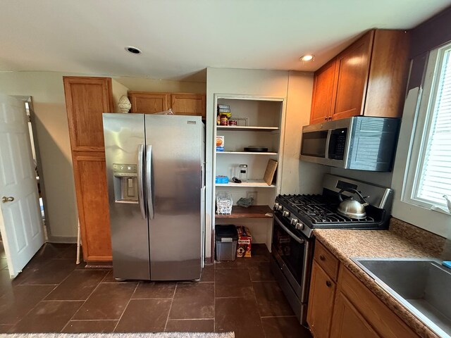 108 Square St, Bluefield, VA 24605 - kitchen with appliances with stainless steel finishes, healthy amount of natural light, brown cabinets, a sink, and recessed lighting
