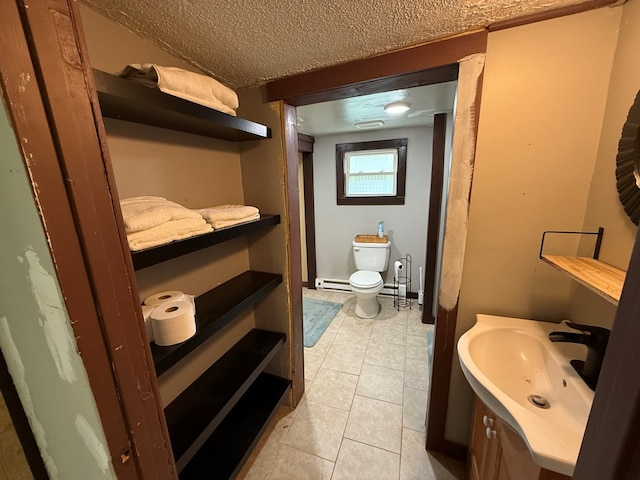 108 Square St, Bluefield, VA 24605 - bathroom featuring toilet, tile patterned floors, baseboard heating, vanity, and a textured ceiling