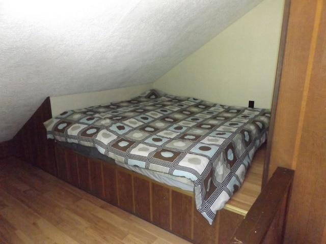 304 Edgewood Dr, Galax, VA 24333 - bedroom with wood finished floors, a textured ceiling, and lofted ceiling