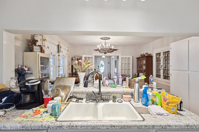 88 W Banner St, Lebanon, VA 24266 - kitchen with a chandelier, light countertops, french doors, and hanging light fixtures