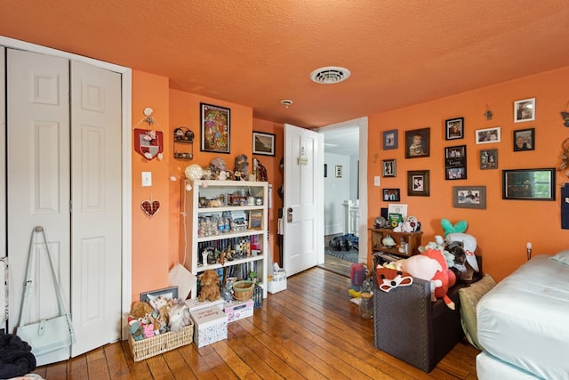 88 W Banner St, Lebanon, VA 24266 - bedroom with hardwood / wood-style floors, a closet, and a textured ceiling