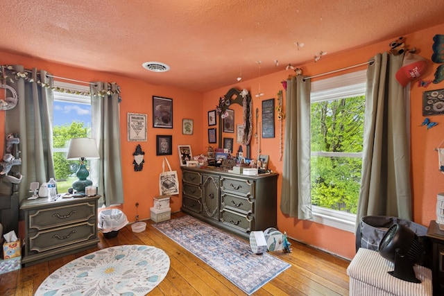 88 W Banner St, Lebanon, VA 24266 - bedroom featuring wood-type flooring and a textured ceiling