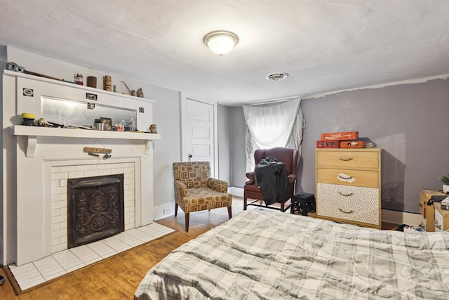 88 W Banner St, Lebanon, VA 24266 - bedroom with wood finished floors and a brick fireplace