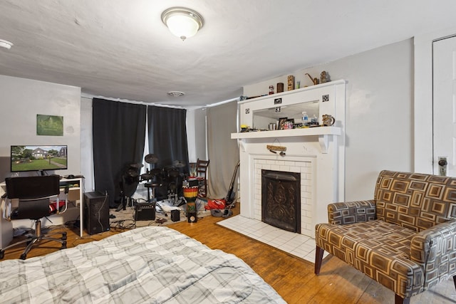 88 W Banner St, Lebanon, VA 24266 - bedroom featuring a tile fireplace, wood finished floors, and an office area
