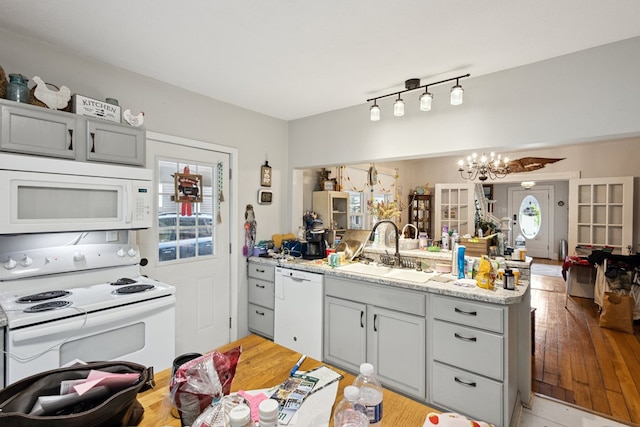 88 W Banner St, Lebanon, VA 24266 - kitchen featuring white appliances, a chandelier, a peninsula, and gray cabinetry
