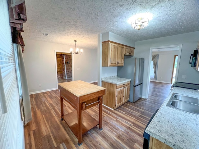 123 Clearwater Ln, Galax, VA 24333 - kitchen with freestanding refrigerator, dark wood-style flooring, a chandelier, light countertops, and a textured ceiling