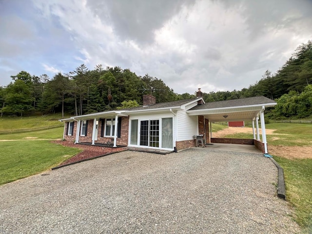 123 Clearwater Ln, Galax, VA 24333 - single story home featuring brick siding, gravel driveway, a front yard, a chimney, and an attached carport
