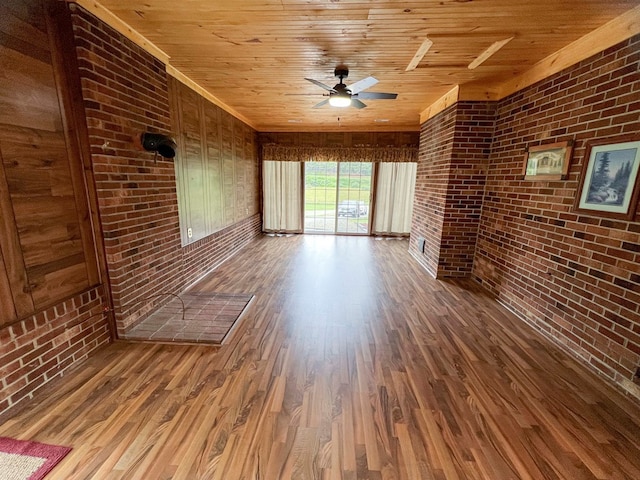 123 Clearwater Ln, Galax, VA 24333 - unfurnished living room with brick wall, wood finished floors, wood ceiling, and ceiling fan