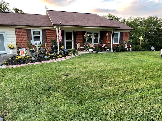 348 Rainbow Cir, Independence, VA 24381 - ranch-style home featuring a front yard, brick siding, and covered porch