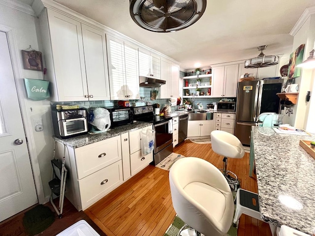 348 Rainbow Cir, Independence, VA 24381 - kitchen with stainless steel appliances, light wood-type flooring, under cabinet range hood, open shelves, and white cabinetry