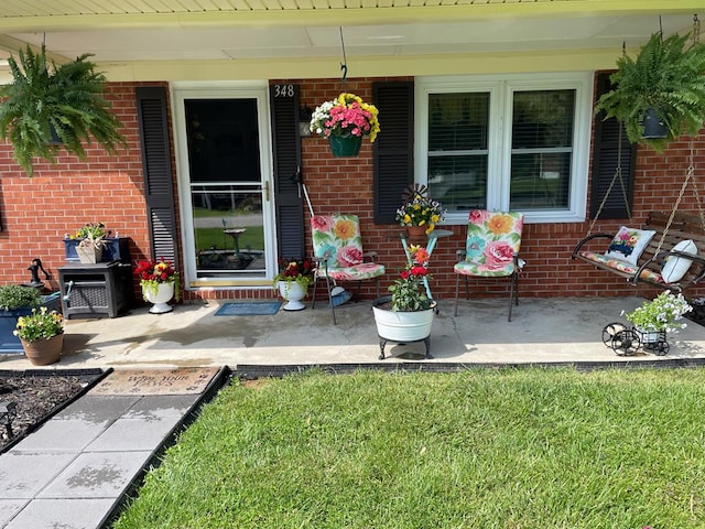 348 Rainbow Cir, Independence, VA 24381 - entrance to property with brick siding, covered porch, and a lawn
