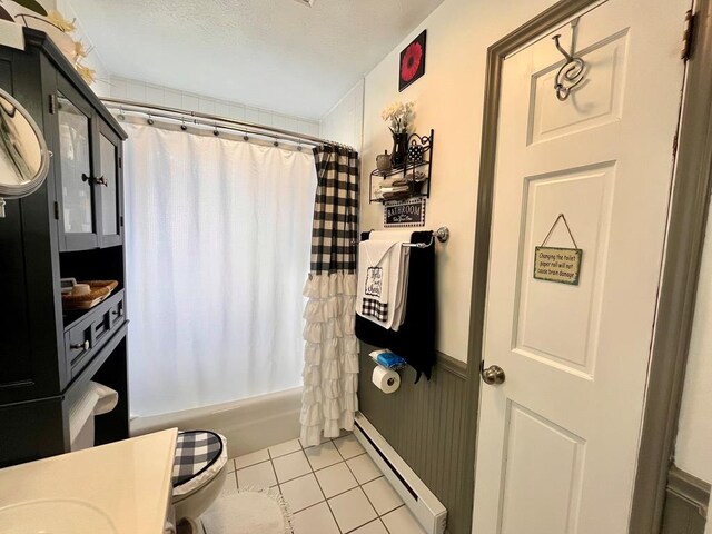 348 Rainbow Cir, Independence, VA 24381 - bathroom with a baseboard heating unit, tile patterned flooring, shower / bath combo with shower curtain, and vanity