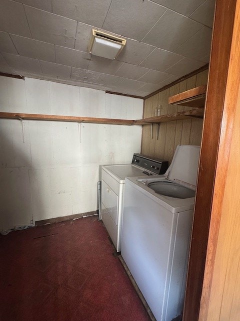 14091 Rocket Boys Dr, War, WV 24892 - washroom with washing machine and clothes dryer and wooden walls