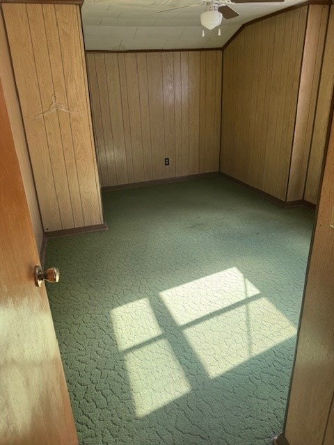 14091 Rocket Boys Dr, War, WV 24892 - unfurnished bedroom featuring wood walls, carpet flooring, and ceiling fan