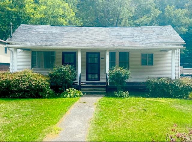 14091 Rocket Boys Dr, War, WV 24892 - bungalow-style home with a porch and a front lawn