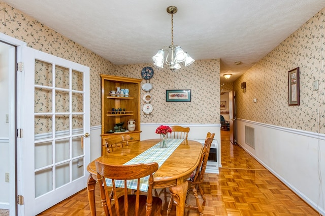 1386 Rocky Hollow Rd, Atkins, VA 24311 - dining room featuring wainscoting, a chandelier, and wallpapered walls