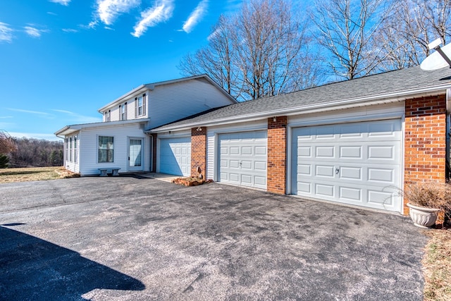 1386 Rocky Hollow Rd, Atkins, VA 24311 - traditional home with brick siding, a garage, asphalt driveway, and roof with shingles