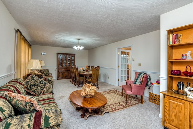 1386 Rocky Hollow Rd, Atkins, VA 24311 - carpeted living room with a chandelier and a textured ceiling