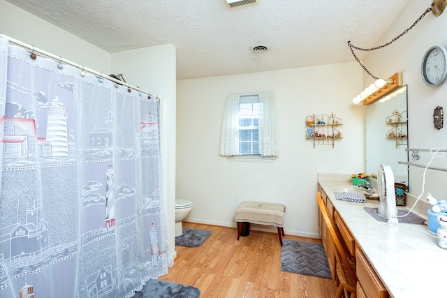1386 Rocky Hollow Rd, Atkins, VA 24311 - full bathroom with double vanity, toilet, wood finished floors, baseboards, and a textured ceiling