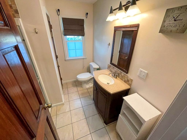 bathroom featuring tile patterned floors, vanity, and toilet