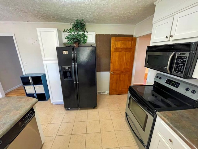 kitchen featuring appliances with stainless steel finishes, a textured ceiling, and white cabinets