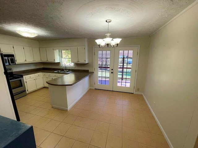 kitchen featuring hanging light fixtures, sink, white cabinets, and stainless steel appliances