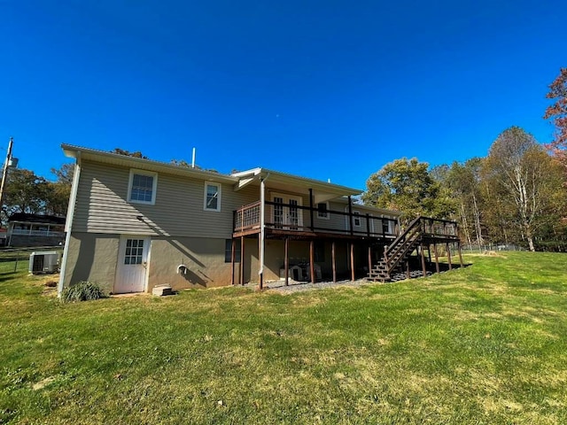 rear view of property with a deck and a lawn