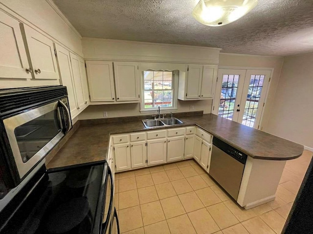 kitchen with white cabinetry, appliances with stainless steel finishes, sink, and kitchen peninsula