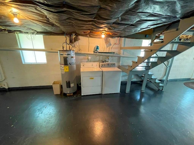 basement with washing machine and clothes dryer and electric water heater