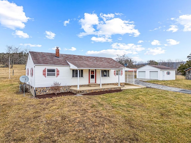 view of front of home featuring an outbuilding, a porch, a garage, and a front lawn