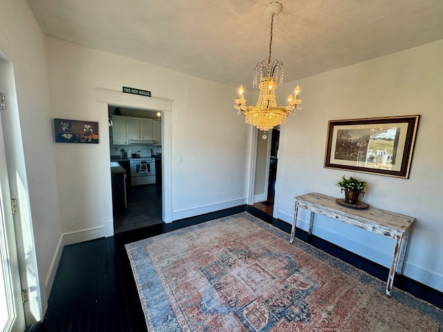 unfurnished dining area with a notable chandelier and dark hardwood / wood-style floors