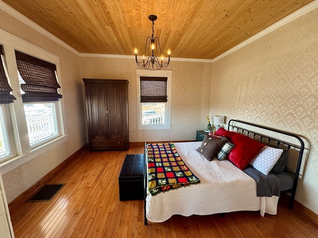 bedroom featuring wood ceiling, crown molding, and light hardwood / wood-style flooring