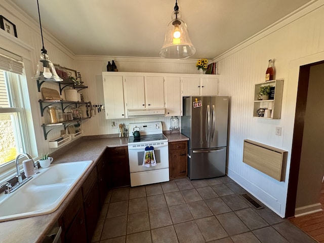 kitchen featuring white cabinets, hanging light fixtures, electric range, and stainless steel refrigerator