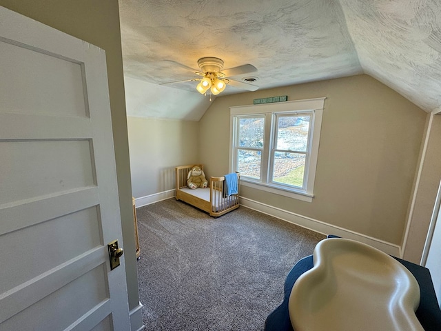 bonus room featuring ceiling fan, lofted ceiling, carpet floors, and a textured ceiling