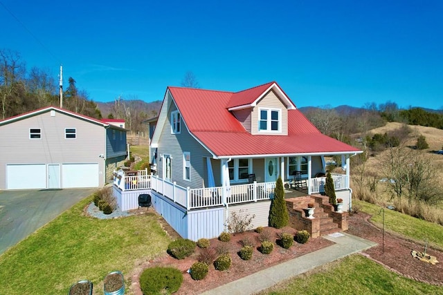 view of front of property with a garage, covered porch, and a front lawn