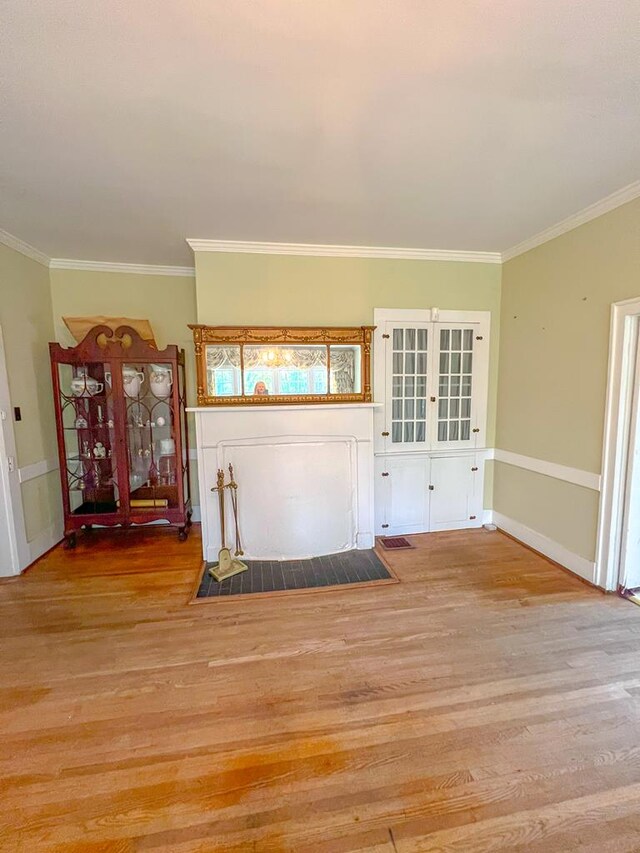 entrance foyer with ornamental molding and light wood-type flooring