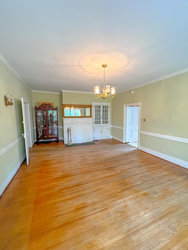 interior space with crown molding, a chandelier, and light hardwood / wood-style flooring