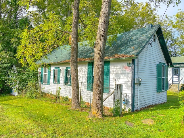 view of home's exterior with a yard