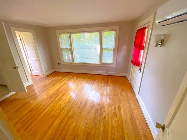 interior space featuring light hardwood / wood-style floors and a wall mounted air conditioner