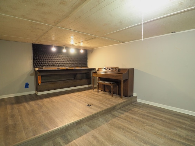 interior space featuring baseboards and wood finished floors