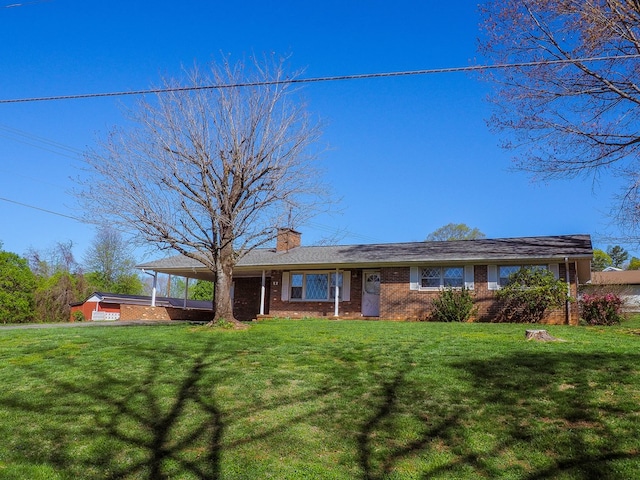 ranch-style house featuring brick siding, a front lawn, and a chimney