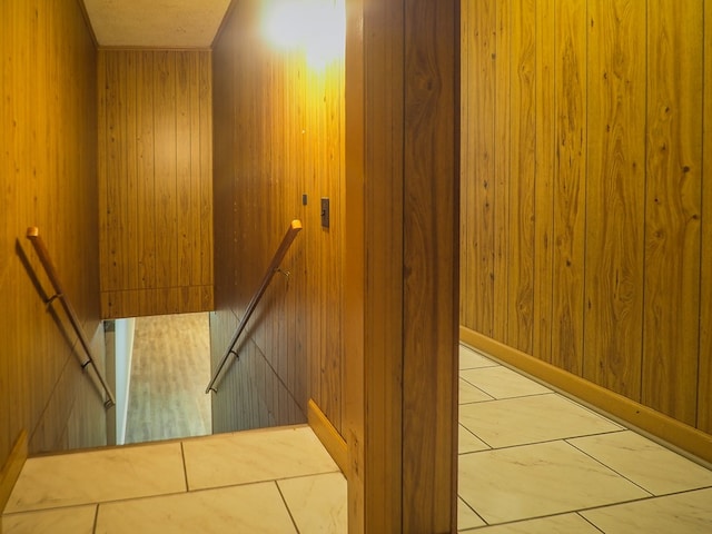 stairs featuring wooden walls