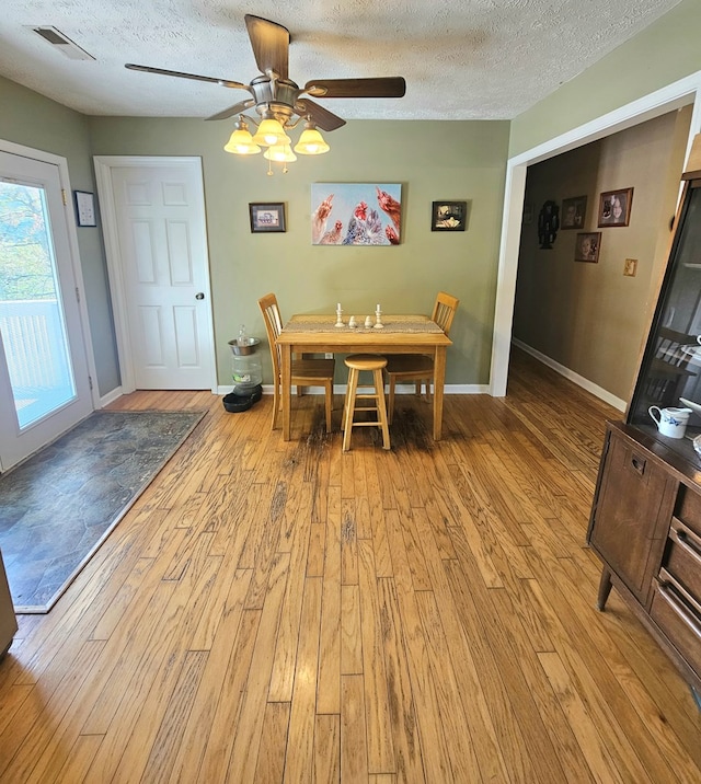 290 Hummingbird Hl, Tazewell, VA 24651 - dining space with wood finished floors, a textured ceiling, ceiling fan, and baseboards